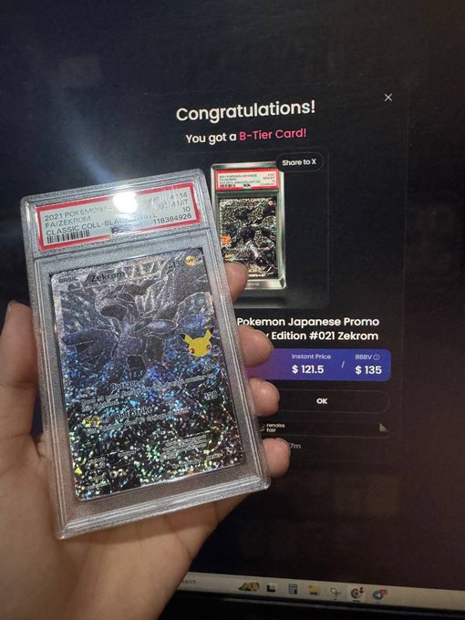 A hand holding a graded PSA 10 Pokémon Japanese Promo card (#021 Zekrom) in front of a computer screen showing a 'Congratulations! You got a B-Tier Card!' message with instant price $121.5.