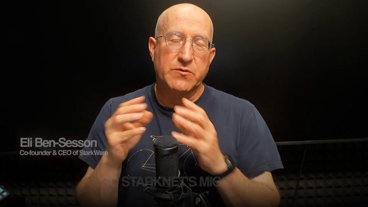 The image features an older man wearing glasses, talking into a microphone with his hands raised. The background of the image is black, making him stand out against it. There are two texts visible in the image that read "El Ben-Session" and "Do you want to upgrade from a regular wallet to a post-quantum safe one? On Starknet, upgrading from a regular wallet to a post-quantum-safe one will be as simple as one click." The man is talking about post-quantum safety in the context of wallets.