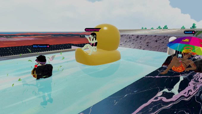 A 3D virtual world scene featuring avatars in a pool, including one in a yellow duck floatie labeled 'EmpressTracy' and another on the right labeled 'Reather' with a colorful umbrella.