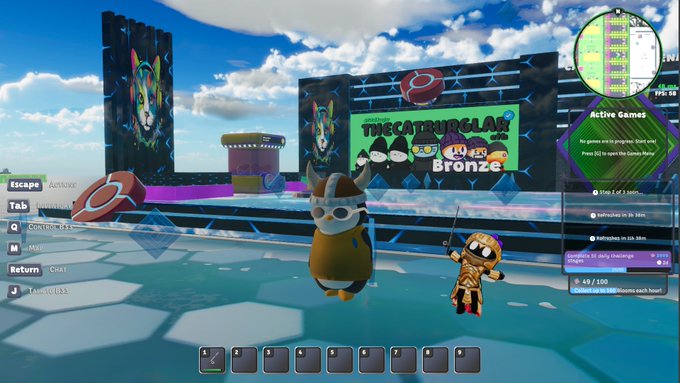 A screenshot from a vibrant virtual "metaverse" game lobby showing two cartoonish avatars (a raccoon and an orange character) standing in a colorful arena with screens displaying "THE CATNIP SLAYS" and "Bronze" rank, alongside game UI elements including chat, active games listing, and player stats (49/100). The image visually reinforces the post's message that the metaverse is an active, evolving space where users can already socialize and play games like this one.
