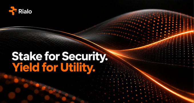 A promotional banner for Rialo with the text 'Stake for Security. Yield for Utility.' displayed against a dark background featuring abstract orange wave-like patterns.
