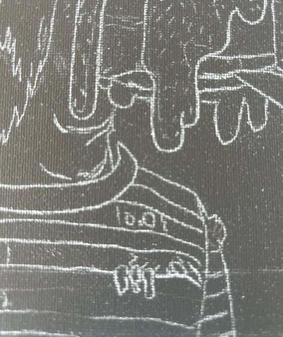 A white chalk drawing on black textured paper depicting a stylized figure sitting on what appears to be luggage, with wavy lines above resembling a cityscape.