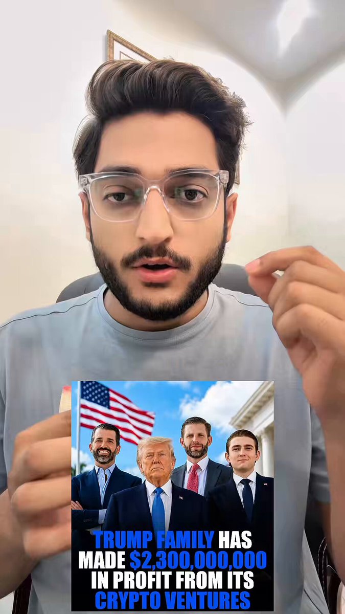 The image features a man wearing glasses holding up an advertisement for Bitcoin, which includes a picture of Donald Trump along with text about the profits made from its use as a currency. The man appears to be promoting or discussing the benefits of using Bitcoin, possibly related to the Trump family's financial gains.