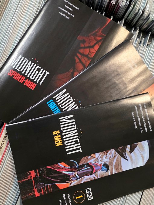 A stack of Marvel Midnight graphic novels including 'Midnight: Spider-Man', 'Midnight: Frost', and 'Midnight: X-Men' published by Marvel.