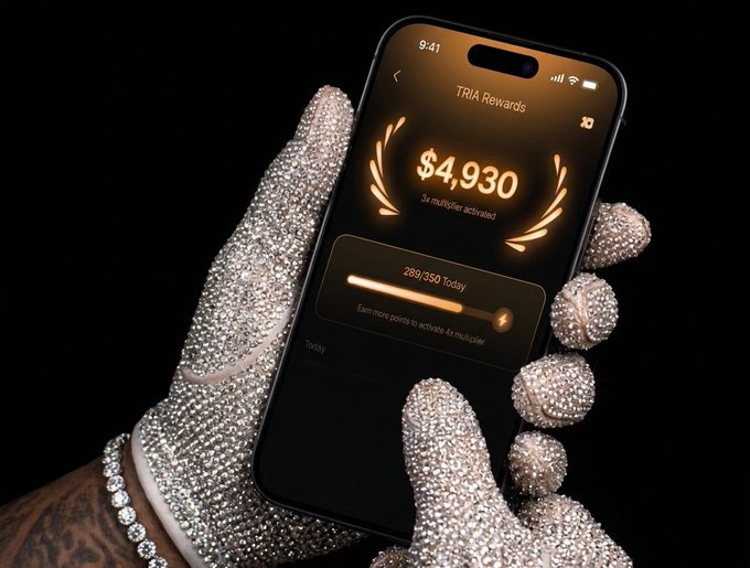The image shows a person's hand holding an iPhone with a gold-colored screen, displaying a message about a reward system for saving money. The phone has a price tag of $4,930 displayed on its screen. The background of the image is black and out of focus, drawing attention to the phone and its features.