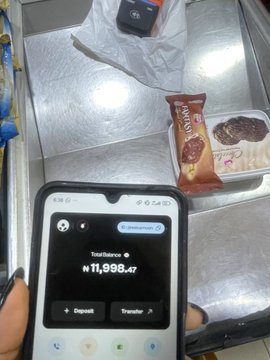 A person holds a smartphone displaying a Spenda wallet balance of ₦11,886.47 (Nigerian Naira) while reaching for a Paddle Pop ice cream pack in a freezer. The image humorously illustrates the poster's caption about using Spenda to trade crypto like cash for everyday purchases like ice cream.