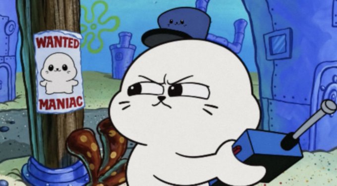 A scene from SpongeBob SquarePants showing a white seal character holding a remote control, with a "WANTED MANIAC" poster of another seal posted on a nearby pole.
