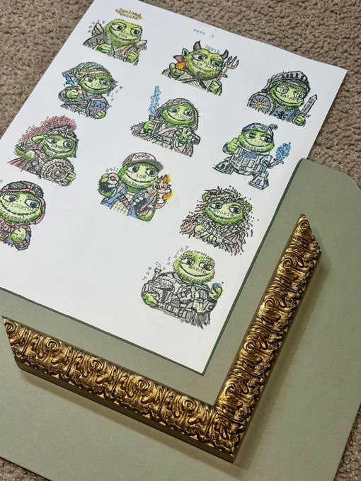 A sheet of hand-drawn sticker designs featuring cartoonish green characters in various costumes, displayed in an ornate gold picture frame.