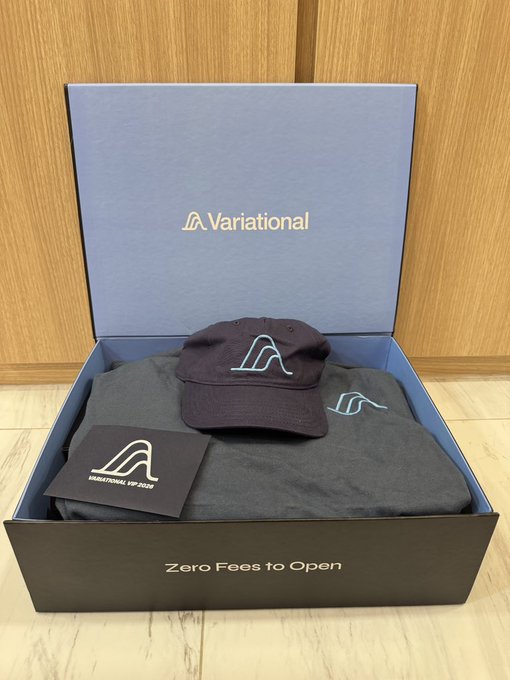 A Variational VIP box containing a branded cap, t-shirt, and sticker pack, with "Variational" displayed on the lid and "Zero Fees to Open" on the front. The image showcases the reward box that was gifted to a community member in recognition of their trading contributions and dedication to the platform.