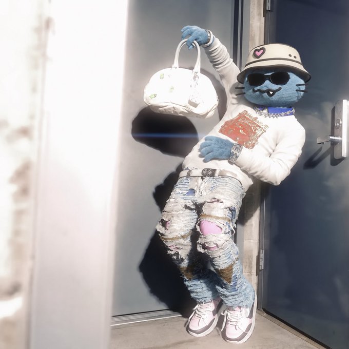 A blue, furry character with fangs, wearing sunglasses, a hat, a white long-sleeved shirt, heavily distressed jeans, and sneakers, holds up a white handbag while leaning against a door.