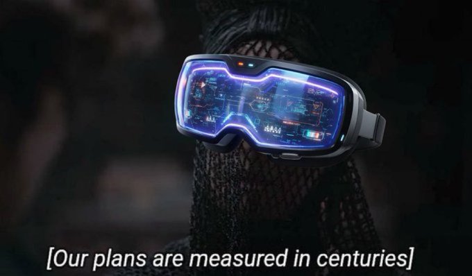 A person wearing futuristic VR goggles displaying glowing blue digital interfaces and schematics, with the text '[Our plans are measured in centuries]' at the bottom.