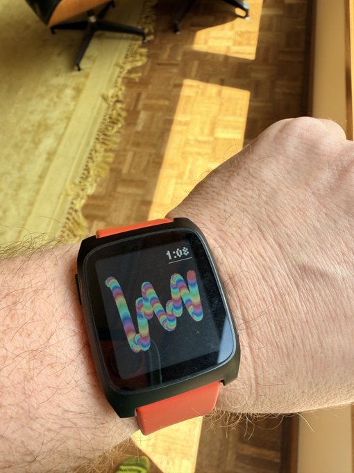 A wrist wearing a black smartwatch with a red band displays a colorful "Squiggle" generative NFT artwork watch face at 1:08, echoing the Chromie Squiggle theme referenced in the caption.
