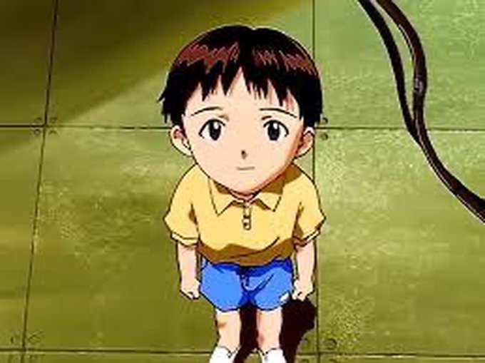 An anime-style image of a young boy with black hair, wearing a yellow shirt and blue shorts, standing on a tiled floor and looking up.