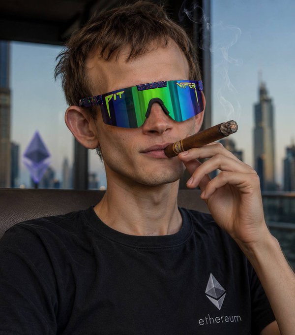 The image features a man wearing sunglasses, holding a cigar up to his mouth while sitting down. There is also an "eth" logo visible in the background of the photo. The caption provided suggests that the man might be selling ether for next to nothing or being referred to as a "mogger." This implies that the man could potentially be involved in some sort of shady business, such as selling illegal substances like drugs or other contraband items.