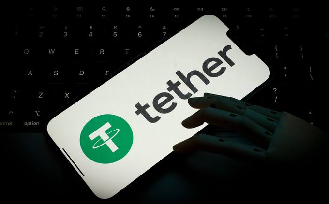 Close-up of a smartphone displaying the Tether (USDT) logo and name against a dark keyboard background.