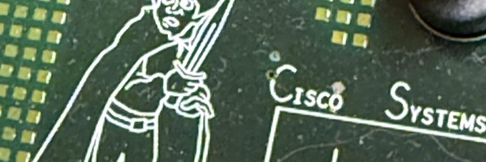 A close-up of a green circuit board featuring the iconic Cisco Systems logo and mascot, with gold contact pads on the left, paired with a post about $FRODO launching on the Robinhood chain—visually evoking the tech/blockchain hardware theme behind the announcement.
