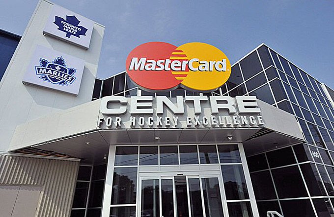 Exterior entrance of the MasterCard Centre for Hockey Excellence featuring the Marlies and Toronto Maple Leafs logos above the doorway.