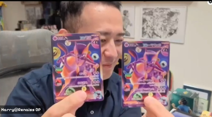 A man holding two identical Pokemon cards, one labeled 'Hridaya CP' and the other '...yi', with text 'Harry@Renaiss OP' visible in the corner.