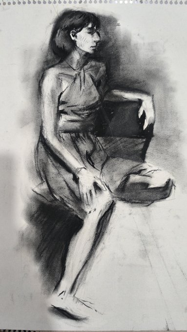 A charcoal sketch drawing of a seated woman in a sleeveless top and skirt, drawn in a sketchy artistic style on white paper.