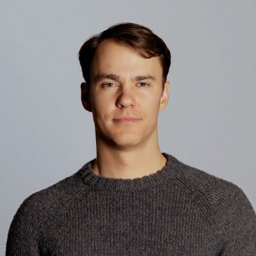 A headshot of a young man with brown hair wearing a dark gray sweater against a neutral gray background. The accompanying post identifies him as Fred Ehrsam, co-founder of Coinbase, reportedly pursuing control of Venezuelan oil fields amid Washington's restructuring of the country's oil sector.