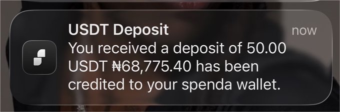 A smartphone notification alert stating "USDT Deposit - You received a deposit of 50.00 USDT ₦68,775.40 has been credited to your spend wallet."