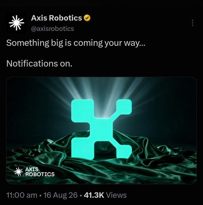 A social media post from 'Axis Robotics' (@axisrobotics) reading 'Something big is coming your way... Notifications on.', featuring an image of a glowing cyan logo with nodes on a dark green fabric background, posted at 11:00 am on 16 Aug 26.