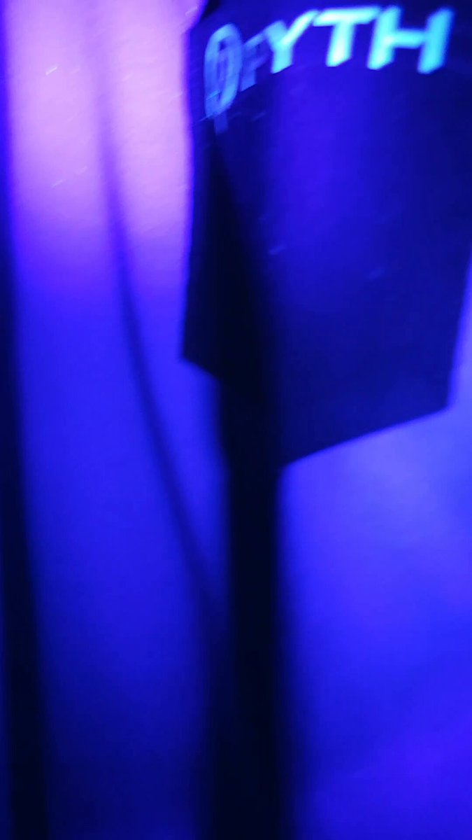The image shows a close-up view of a black object that has the word "PYTH" written on it. The object appears to be a speaker or microphone, possibly used for recording or amplifying sound. It is positioned against a blue background with white lines and lights, which creates an interesting contrast in color and lighting. The image also contains text that reads: "Hayo legends Im stil digesting what $PYTH cooked @PythNetwork is actually changing the game with bridging TradFi / Defi Launching real proprietary 24/7 indices for big US stocks like NVDA, TSLA, AAPL & gold, silver, oil, ...". This text suggests that the image might be related to a discussion or analysis of the stock market and its impact on various industries.