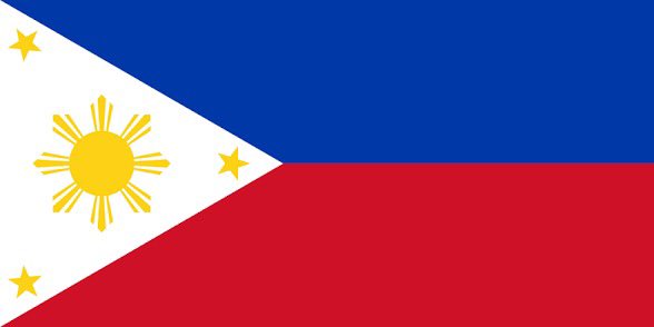 The image features a flag with red, white, and blue colors, along with yellow sun rays at the top of the flag. The flag appears to be waving or blowing in the wind, as indicated by its movement across the frame. The flag is displayed against a gray background, which contrasts nicely with the vibrant colors of the flag. This image could be related to a post about the flag's design and features on Binance, where users can learn more about the flag's history and significance or even trade it for other currency.