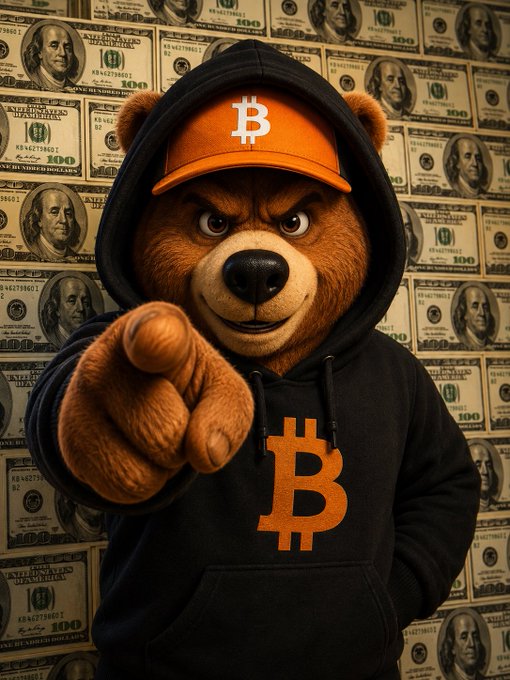 An anthropomorphic bear wearing an orange Bitcoin cap and black hoodie with an orange Bitcoin logo, pointing at the camera against a backdrop of hundred-dollar bills.