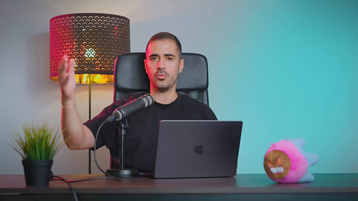 The image shows a man sitting at a desk with an open laptop computer, wearing a black shirt. The background features a green wall and a lamp that casts a pinkish-orange glow. There are two small stuffed animals placed near the edge of the desk - one is a pink animal, while the other is brown. The post about ICP explains how to use it for Bitcoin mining or creating a wallet, but there's no direct connection between the image and the post.