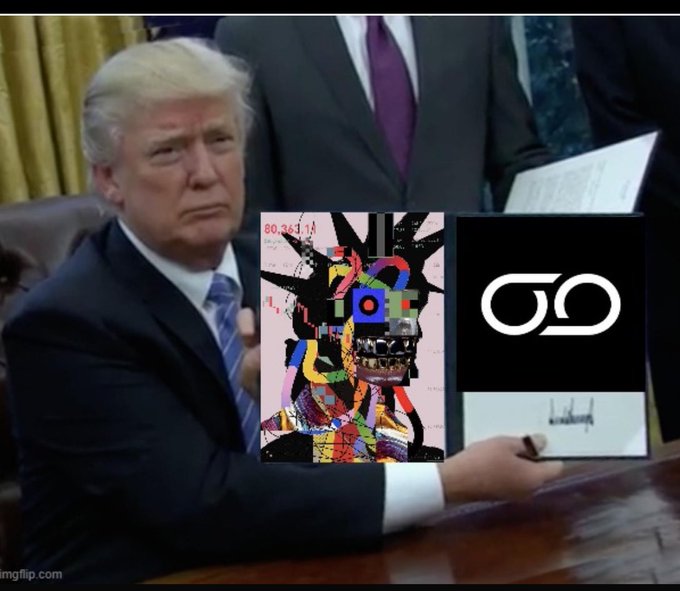 The image features a man wearing a suit, sitting at a desk with a book open in front of him. The book has an art piece or drawing on its cover that includes a face and text elements. The man appears to be signing the book while holding it up for the camera. In the background, there is another person who seems to be observing the scene. The image also contains some text that reads "Good morning legends consistency is showing up even when there's no result yet stay @NomismaNetwork and keep exploring @useTria cards fam".