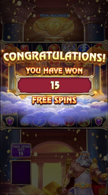A slot game screen displays "CONGRATULATIONS! YOU HAVE WON 15 FREE SPINS" with a Zeus figure in the corner. The image illustrates the post's claim of a major win, though the screen actually shows a standard 15 free spins bonus rather than a 1000X multiplier, suggesting promotional hype from ToshiBet.