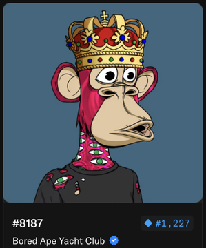 urn of gold and red flowers, crown with blue jewels, and a pink face with green eyes are featured on the cartoon character's head.