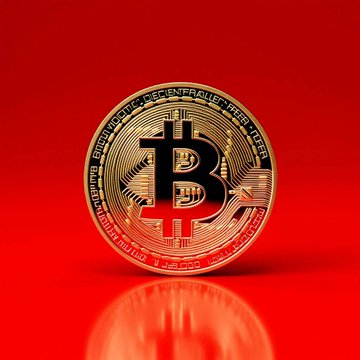 The image shows a gold-colored Bitcoin symbol sitting on top of a red background against a black background. The Bitcoin symbol is surrounded by a white line, indicating its prominence in the composition. A text box at the bottom right of the image contains information about Bitcoin, specifically stating that it has reached total liquidations over the last 24 hours and is currently below $61,500.