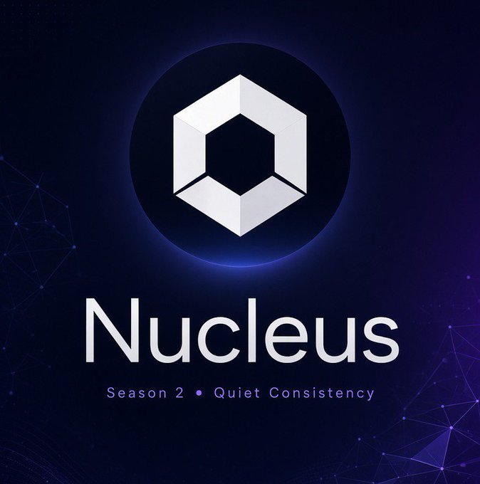 A logo/graphic for 'Nucleus' Season 2 with the tagline 'Quiet Consistency,' featuring a white hexagonal 3D cube design on a dark blue background with glowing purple network/geometric patterns.