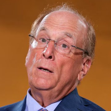 An older man with glasses, wearing a blue suit jacket and light blue shirt, appears to be speaking at a press event or conference. The image likely relates to Larry Fink, CEO of BlackRock, whose company recently saw clients sell $202.5 million worth of Bitcoin ($BTC).