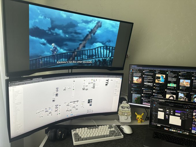 A multi-monitor gaming and productivity setup featuring a TV playing an anime with the subtitle "Kikufuku's not like other souvenirs," alongside an ultrawide monitor displaying a note-taking app, and two additional screens showing Discord and development tools, accompanied by a Pikachu figurine and Apple Studio Display on a wooden desk. The image illustrates a dedicated workspace for "locking in," with multiple screens ready for exploring NFTs, predictions, and other planned tasks.