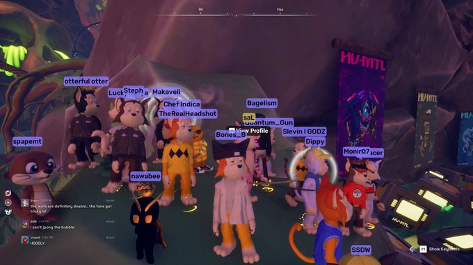 A screenshot from a 3D game shows numerous cartoon animal avatars (otters, foxes, and other creatures) gathered together with player names like 'LuckSteph', 'Chef Indica', 'Bagelism', 'Monir07', and 'nawabee' displayed above their heads, with a 'HUNT!' banner on the right side.