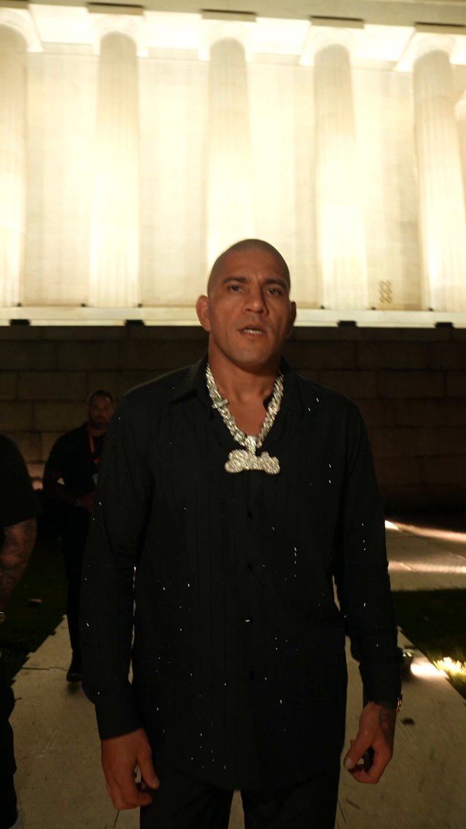 The image features a man wearing a black shirt, standing in front of a building with columns. The man appears to be posing for a photo or video, possibly at an event related to UFC (Ultimate Fighting Club). The caption of the image reads "I'M READY FOR IT" and "UFC WHITE HOUSE LIVE Sunday June 14 at 8pmET on @ParamountPlus #UFCWhiteHouseLive".
