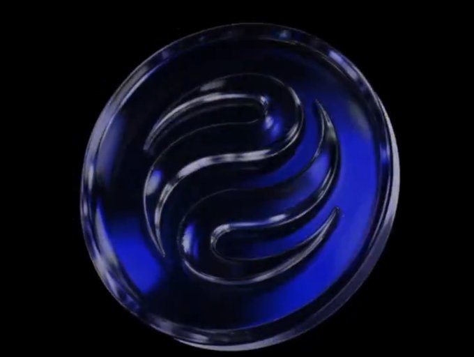 A glossy blue circular emblem with a raised, swirling abstract symbol is centered against a black background.