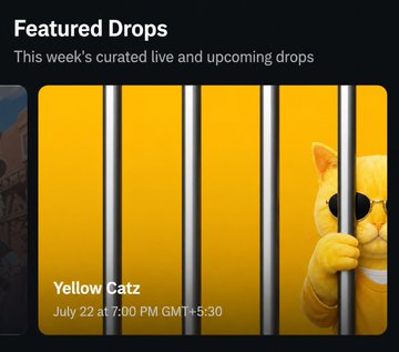 A dark-themed digital interface showing 'Featured Drops - This week's curated live and upcoming drops' with a 'Yellow Catz' event scheduled 'July 22 at 7:00 PM GMT+5:30' featuring an orange cat behind yellow prison bars.