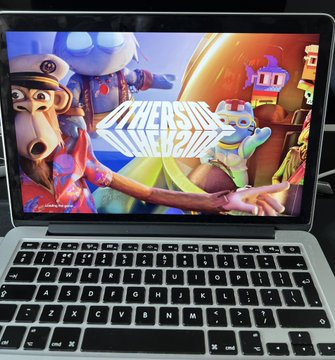 A laptop displays the title screen of "Otherside 2022," an animated intro featuring colorful, stylized characters. The image ties to the post by serving as a nostalgic throwback to the Otherside Meta project, marking one year since its launch.