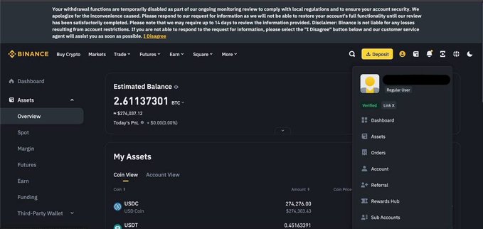 A screenshot of a Binance cryptocurrency dashboard showing an estimated balance of 2.61137301 BTC (approximately $275,037.12), with the disclaimer noting that withdrawal functions are temporarily disabled due to an ongoing review.
