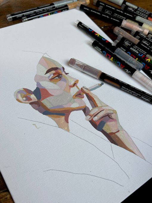 A cubist-style portrait of a person smoking is drawn on paper using Arteza markers, with several marker caps scattered around the edges of the paper.