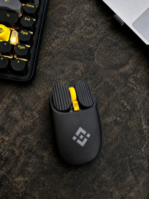 A sleek black gaming mouse with a yellow scroll wheel rests on a dark textured surface beside a partially visible keyboard with "Home," "End," "Pgup," and "Pgdn" keys, ready to "click to start the week."