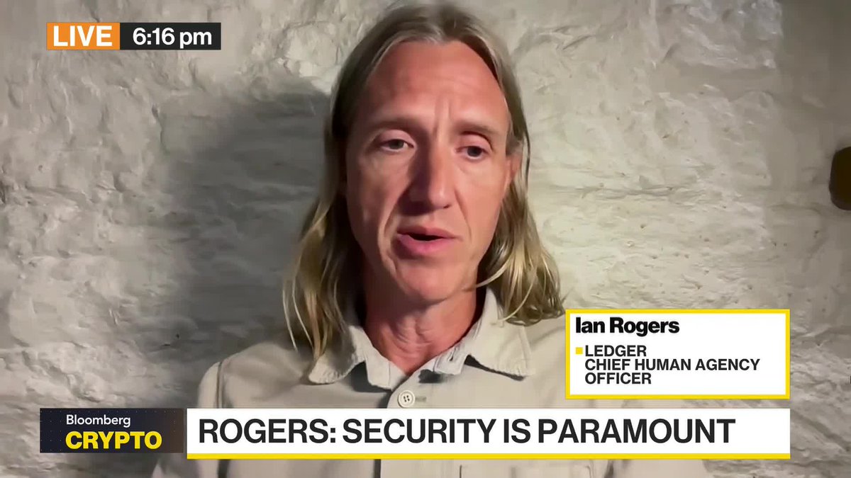 Ian Rogers, Ledger's Chief Human Agency Officer, appears on Bloomberg Crypto Live at 6:16 pm discussing the headline "ROGERS: SECURITY IS PARAMOUNT," illustrating his point about AI agent security through the analogy of leaving car keys with a teenager.