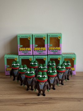 A collection of boxed 'BOX-FUN' collectible figurines featuring cartoon frog characters in ninja-style outfits, arranged on a wooden surface.