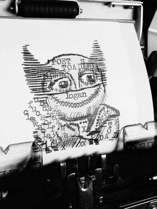 A black-and-white photo shows a typewriter with a sheet of paper where a face has been typed using letters, numbers, and punctuation, with the words "POET S TOA," "logan," and "TOADA" embedded in the design. As a "wip" (work in progress), the piece appears to be an experimental typewriter art portrait still being developed, with partially formed features suggesting the artwork is not yet complete.