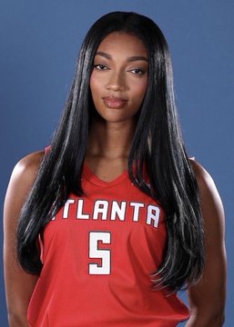 A young woman with long, straight black hair poses for an official portrait wearing a red Atlanta basketball jersey with the number 5, which ties to Angel Reese's Defensive Player of the Year achievement.