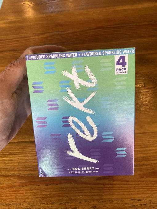 A hand holding a 4-pack box of 'LOOK' brand flavoured sparkling water in 'Sol Berry' flavor, powered by Solmar.